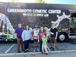 Family in front of Gene Machine bus