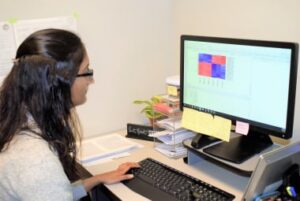 Postdoc, Sneha Mokashi, reviews computer data