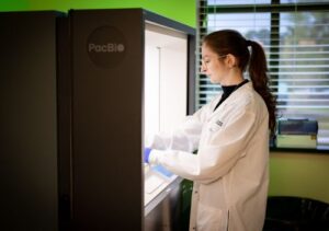 GGC lab technologist works with PacBio instrument