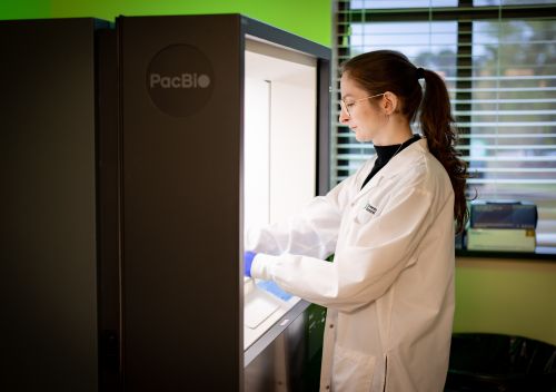 GGC lab technologist works with PacBio instrument